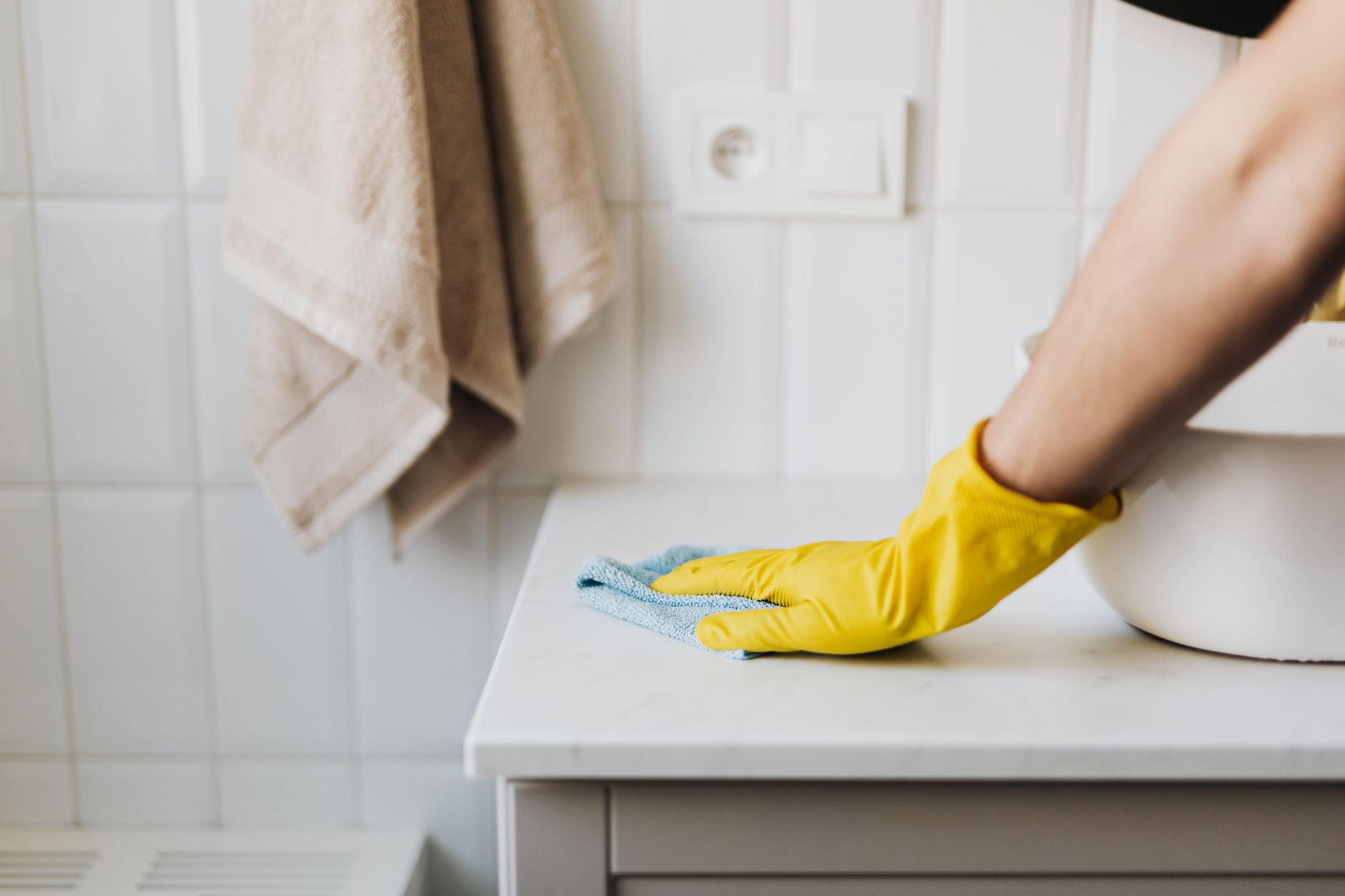 Professional cleaner polishing a clean countertop surface in an office or home environment
